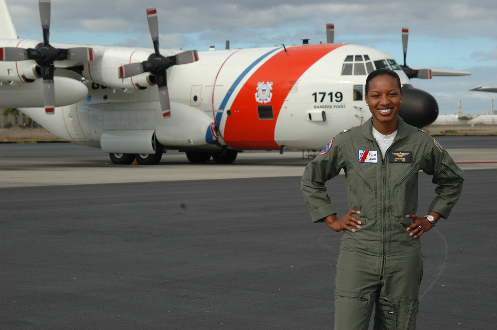 The first African American female pilot in the Coast Guard, LTJG Jeanine McIntosh poses in front of her HC-130.